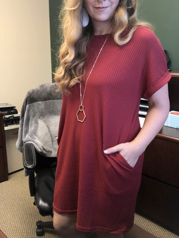 reviewer wearing the dress and with their hands in their pockets