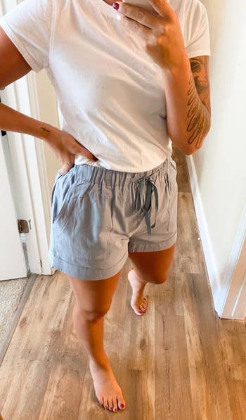 a reviewer wearing the shorts in light blue