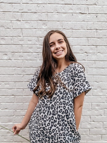 reviewer wearing leopard print version of the short sleeve dress