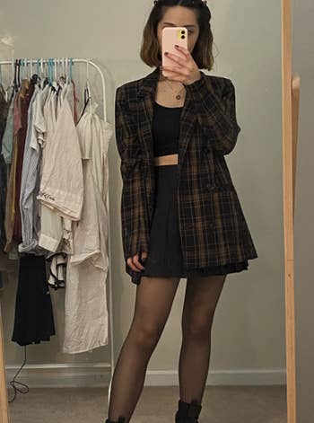 different reviewer wearing with tights, crop top, and blazer