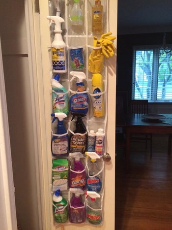 reviewer's over the door plastic shoe organizer with cleaning supplies in it