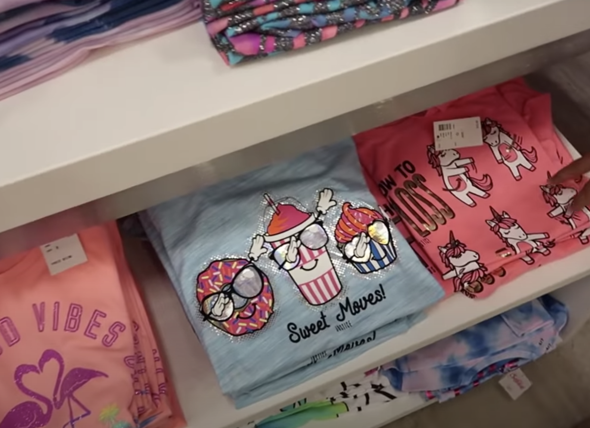 A shirt with a donut and cupcake that says &quot;Sweet moves!&quot;