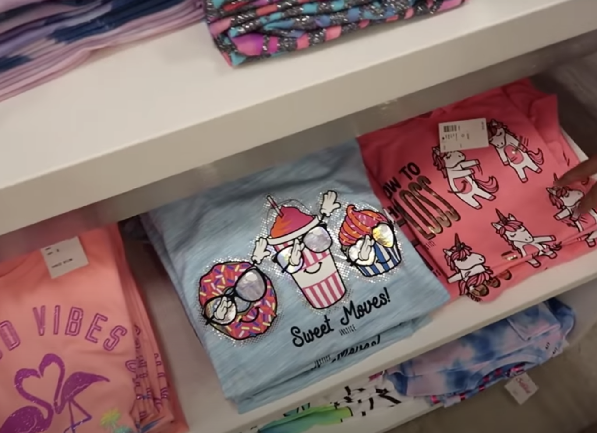 A shirt with a donut and cupcake that says "Sweet moves!"