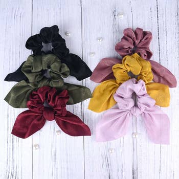 the scrunchies in black, olive, burgundy, mauve, yellow, and light pink