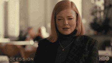 Sarah Snook as Shiv furrowing her brows and then looking around, worried