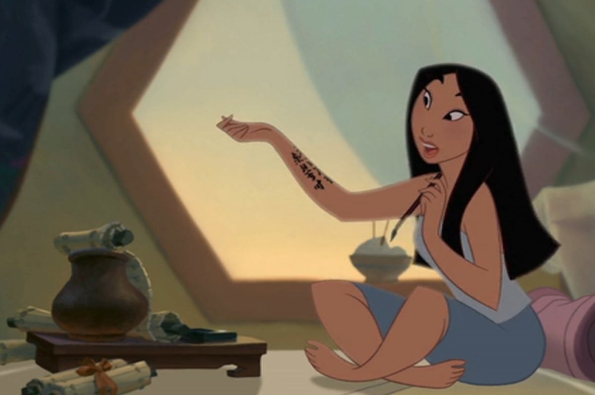 Still from animated Disney cartoon Mulan drawing Chinese characters on her right arm with a calligraphy brush