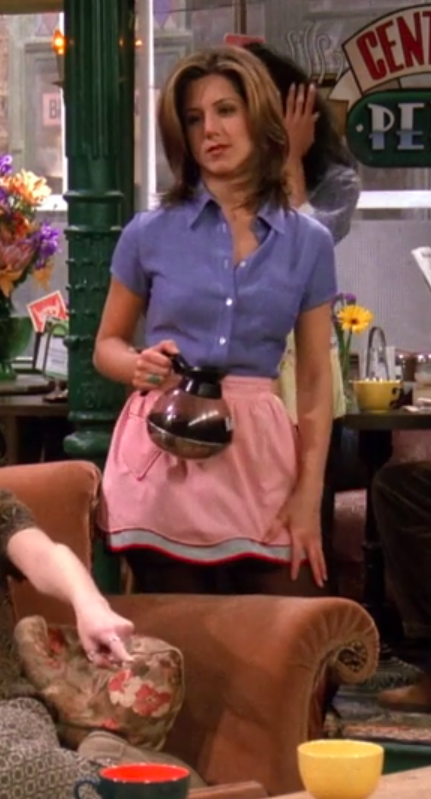 Rachel wearing a short-sleeve button-up, an apron, a miniskirt, and tights