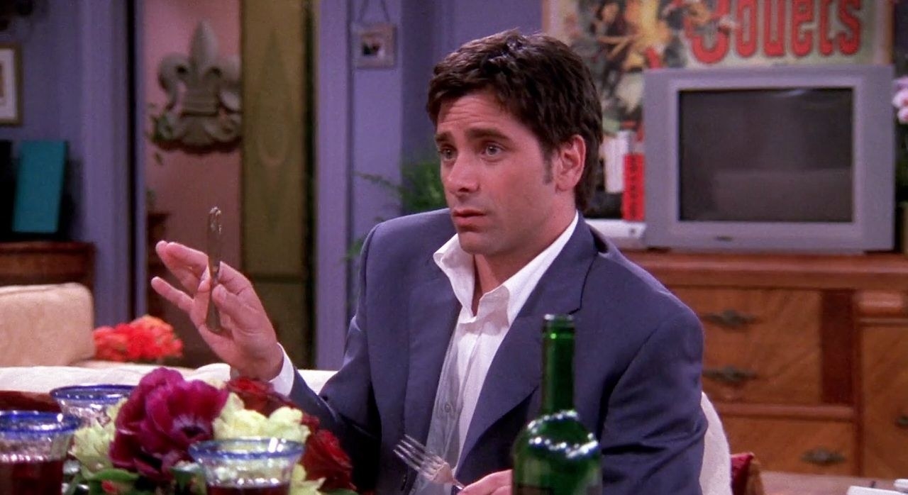 John Stamos sits at the dinner table in Monica&#x27;s apartment as Zack