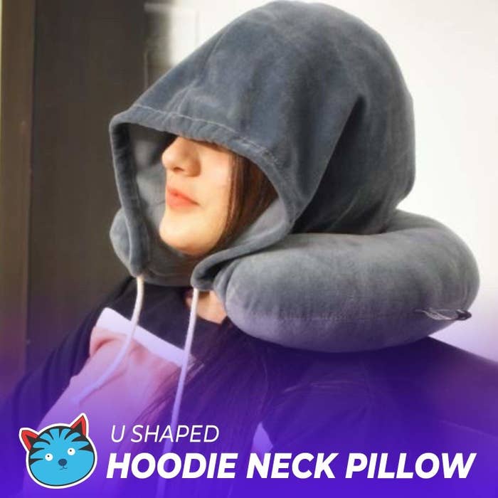 A person wearing the hoodie neck pillow.