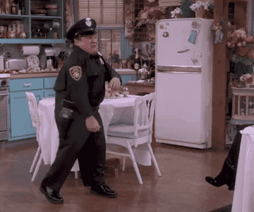 Danny DeVito dances around in a police uniform as Roy