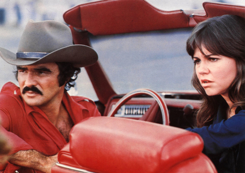 Sally and Burt in a car during one of their film scenes