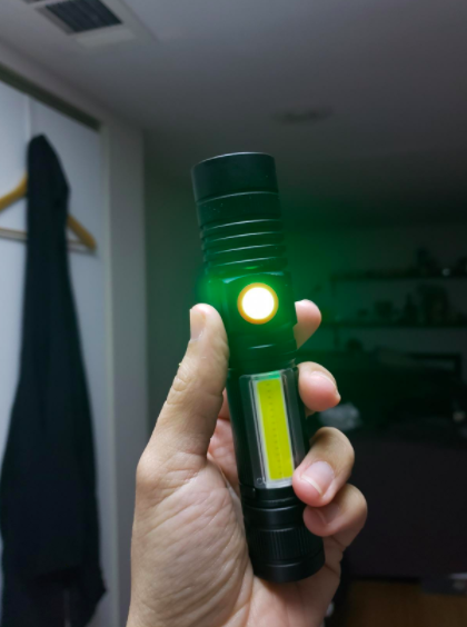 a reviewer holding the flashlight