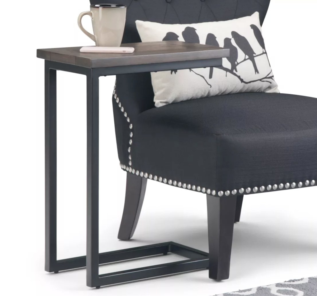 A C-shaped end table with metal frame and wood top
