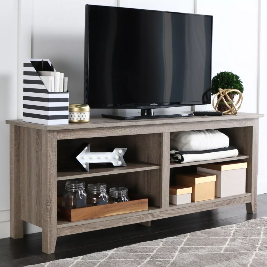 A wooden TV stand with 4 shelves