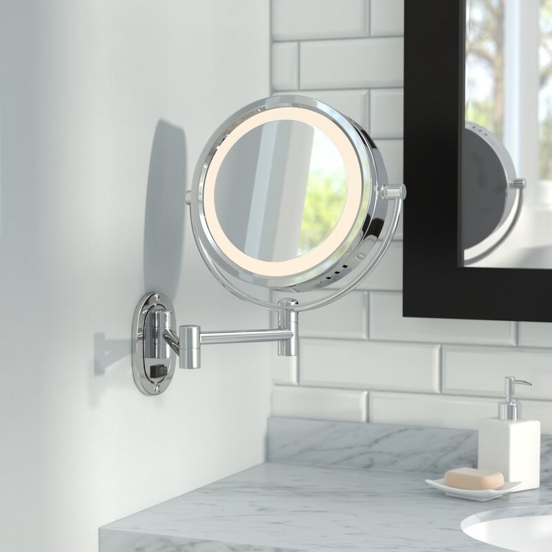 The mirror mounted on a bathroom wall 