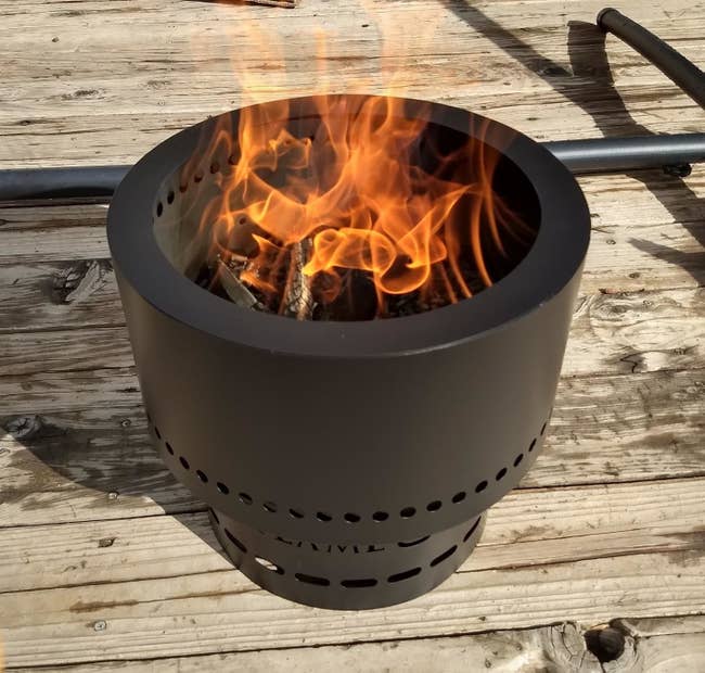 Reviewer using fire pit with wood pellets