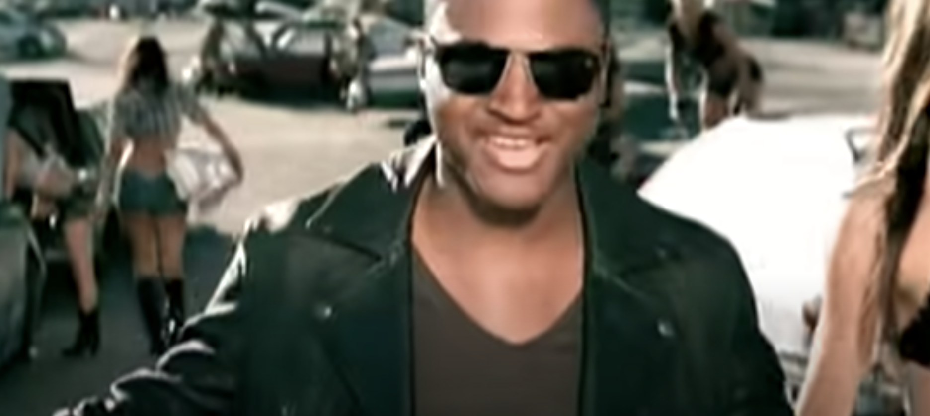 Taio walking down the street and singing