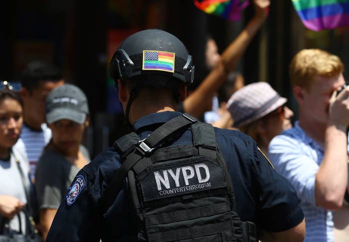 NYPD officer with a pride flag on the back of their helmet