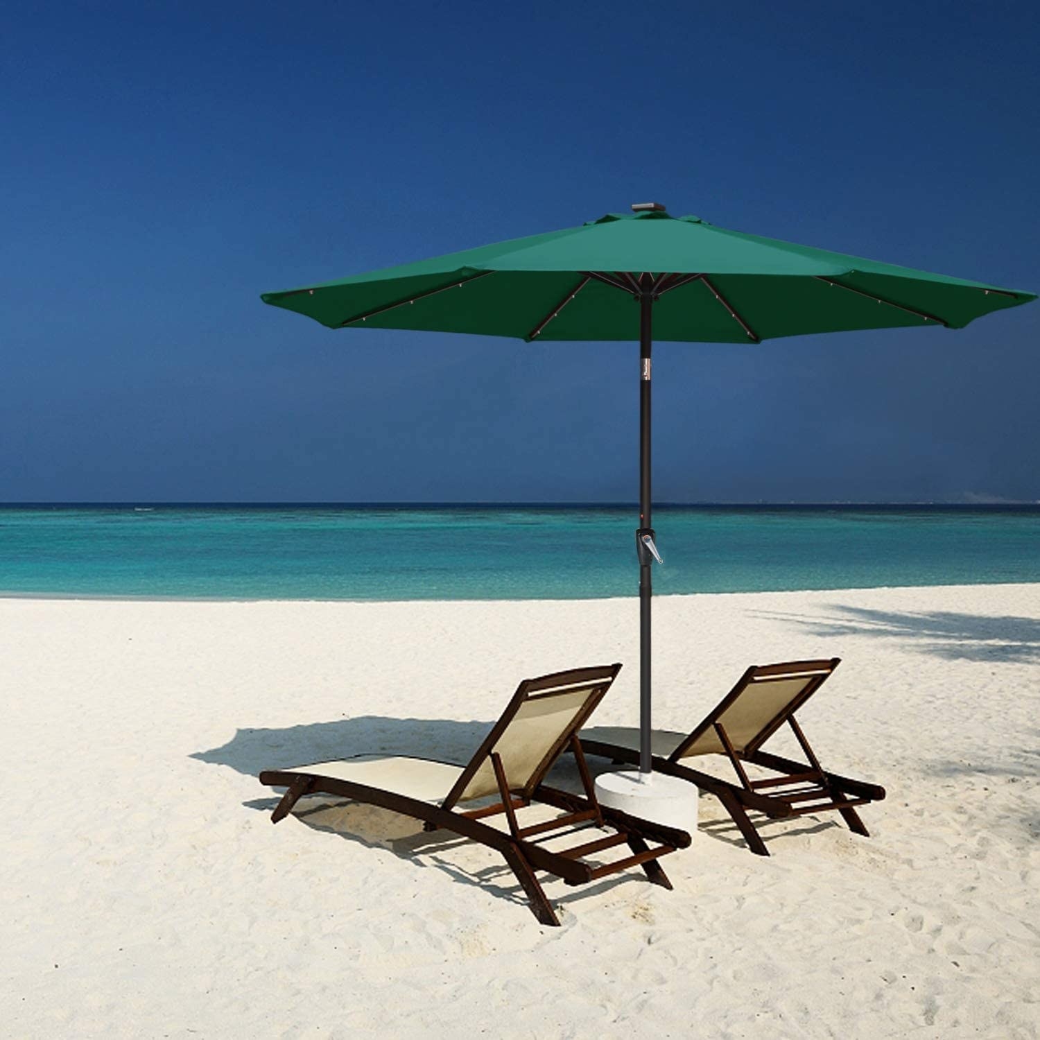 The umbrella over two patio chairs at a beach