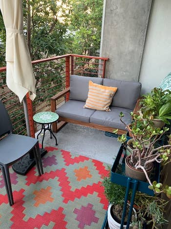 the gray loveseat on a reviewer's balcony