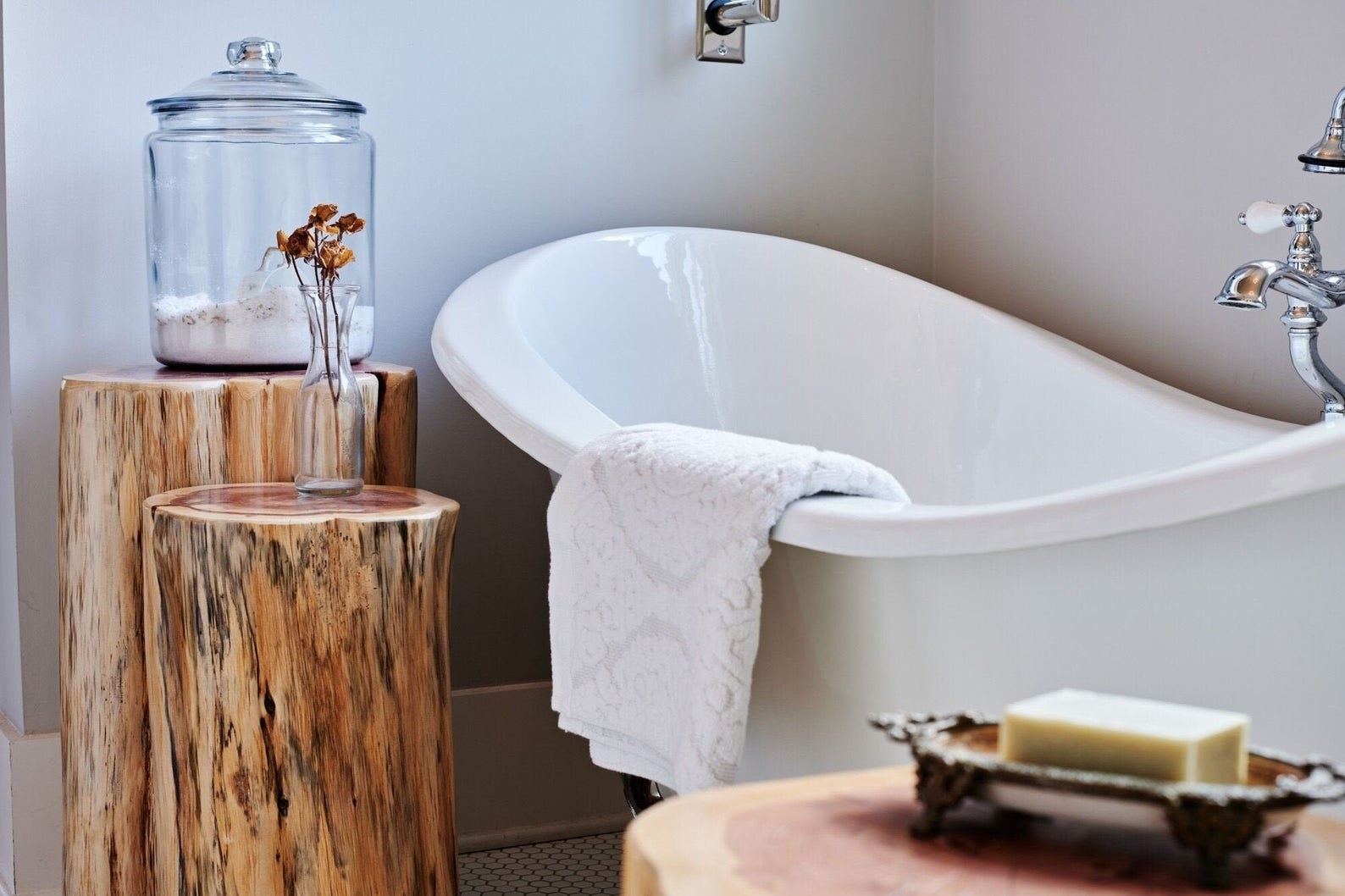 Wooden end tables in bathroom next to tub