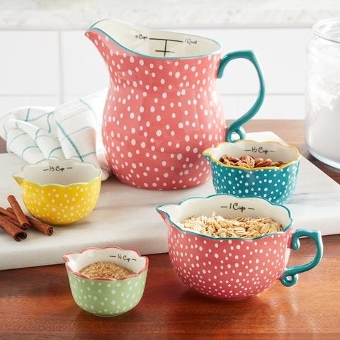 teal, coral, yellow, and green dotted measuring cups