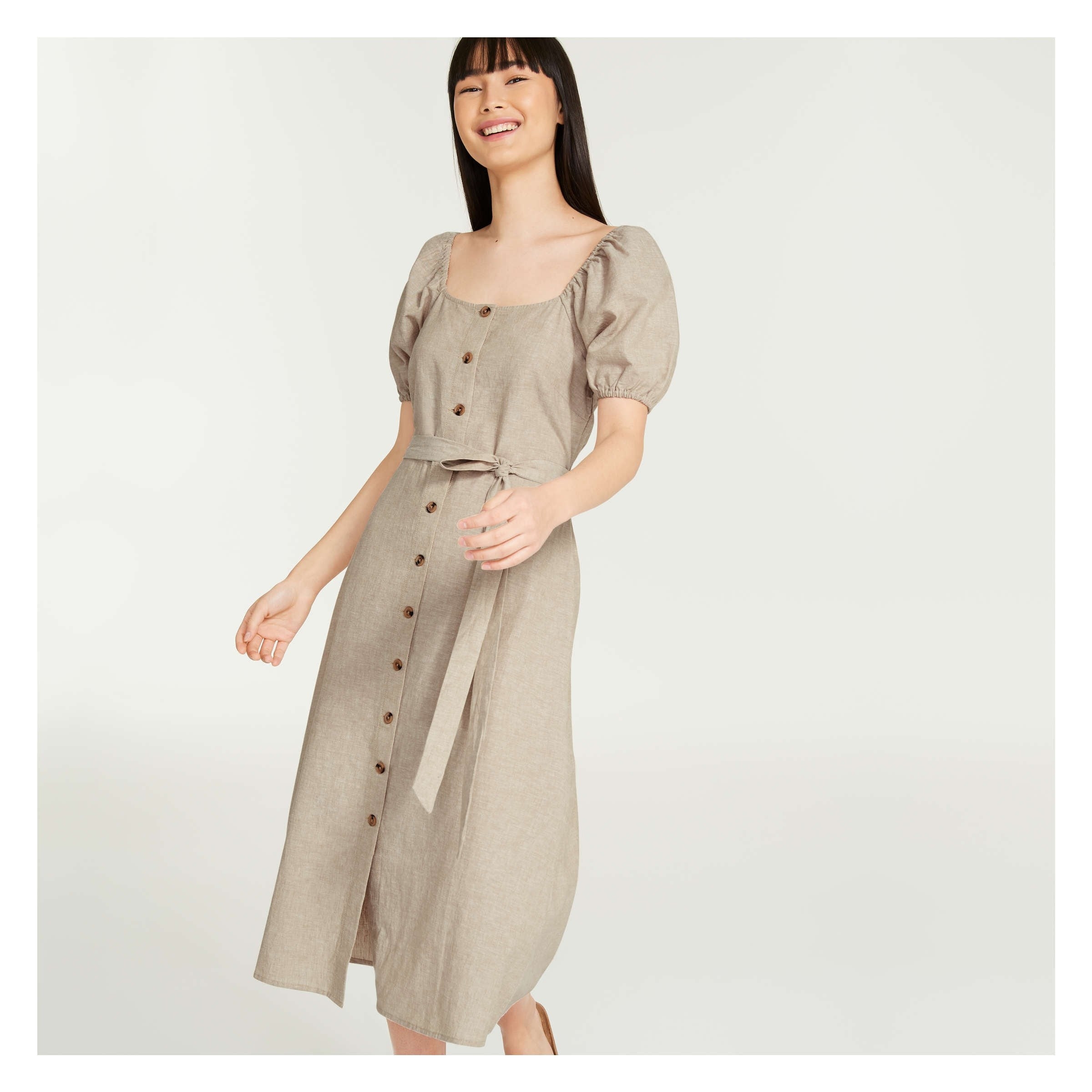 A person wearing the puff-sleeved button-up dress