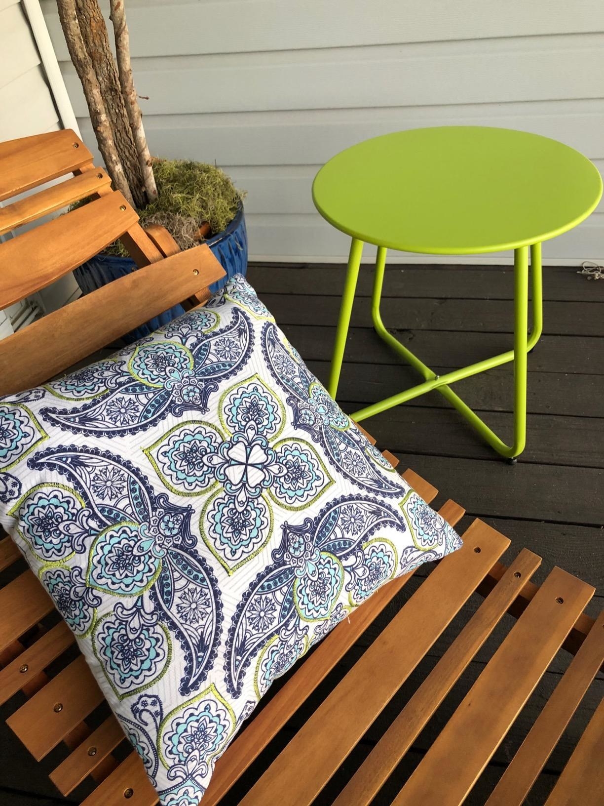 the green table next to a reviewer's chaise lounge