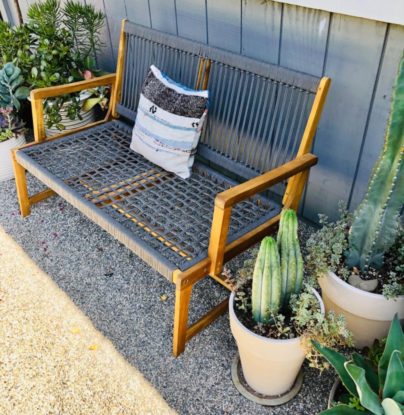 the gray woven bench in a reviewer&#x27;s yard