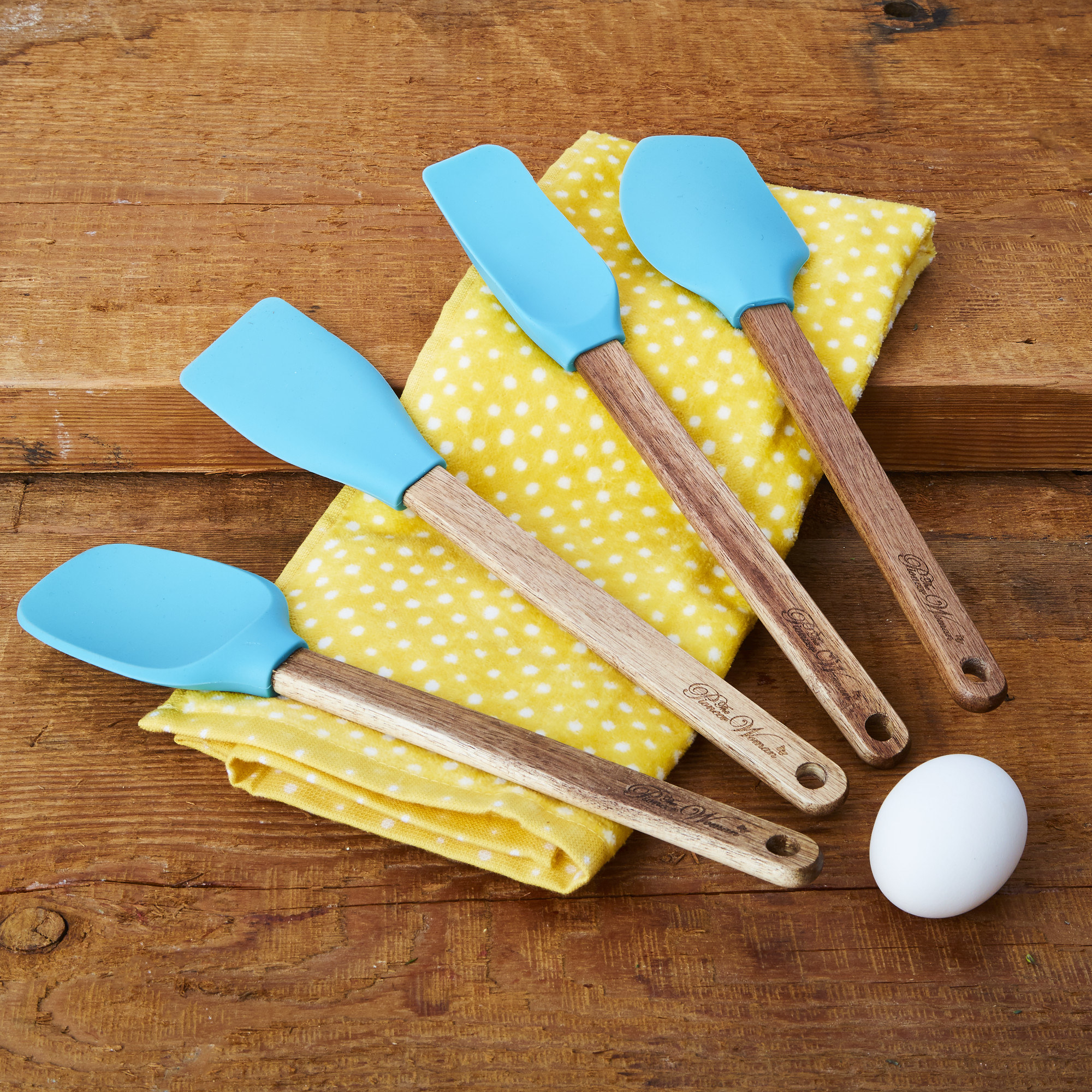 the wooden set with blue tops laying on a yellow polka dot towel
