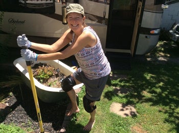 a reviewer smiling while wearing the knee pads and gardening