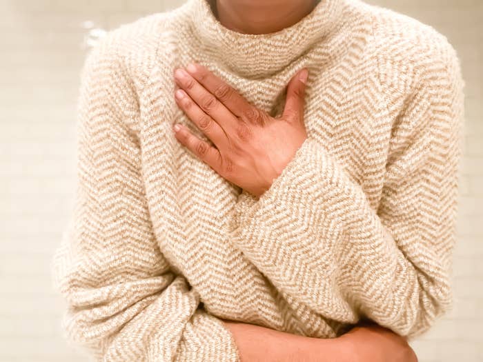 A person holding their hand to their chest
