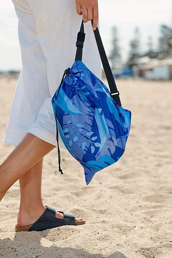 a model holding the included carrying pouch 