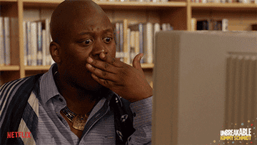 Titus from Unbreakable Kimmy Schmidt looking shocked at a computer