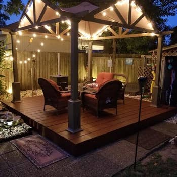a reviewer photo of an outdoor gazebo with string lights along the edges 