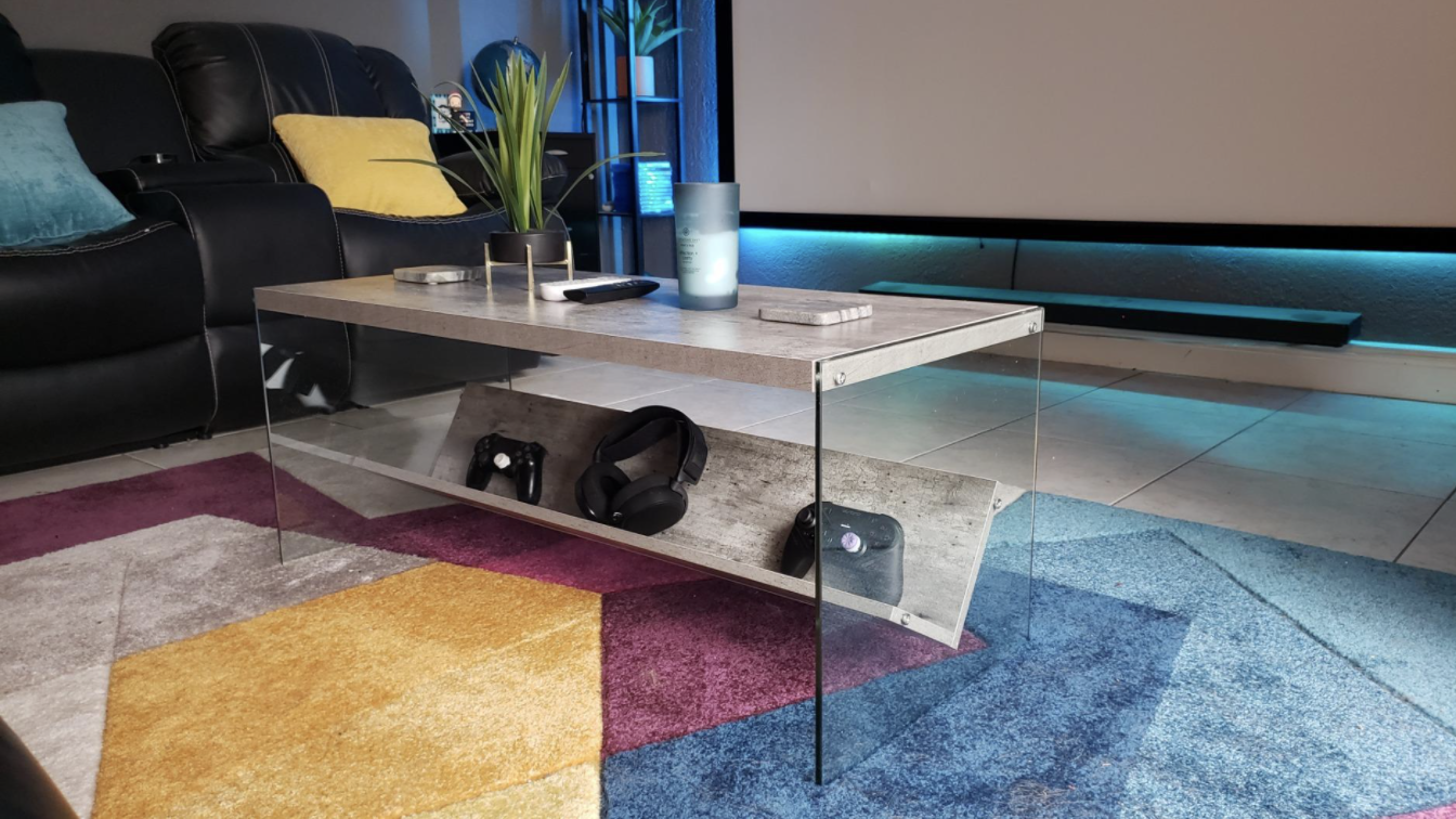 Reviewer&#x27;s rectangular faux marble and glass coffee table in the middle of a living room