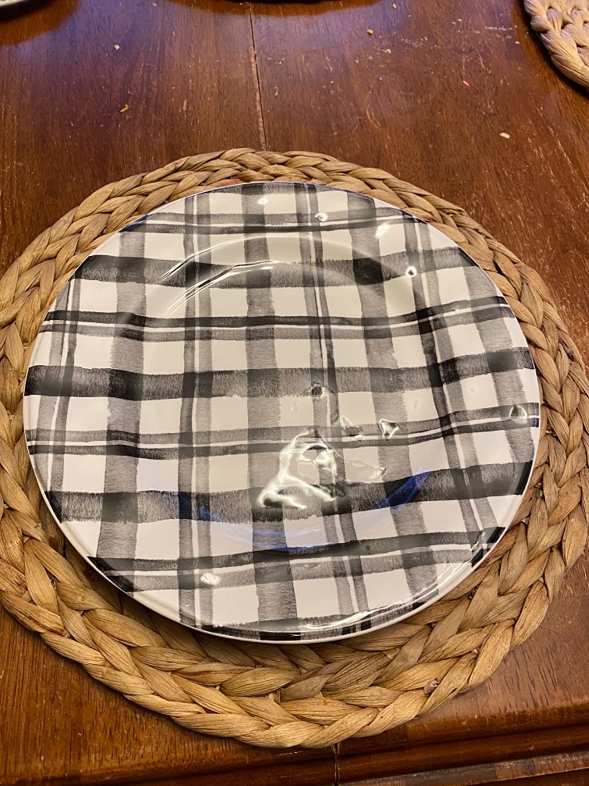 reviewer image of the bico black and white plaid plate atop a woven placemat 