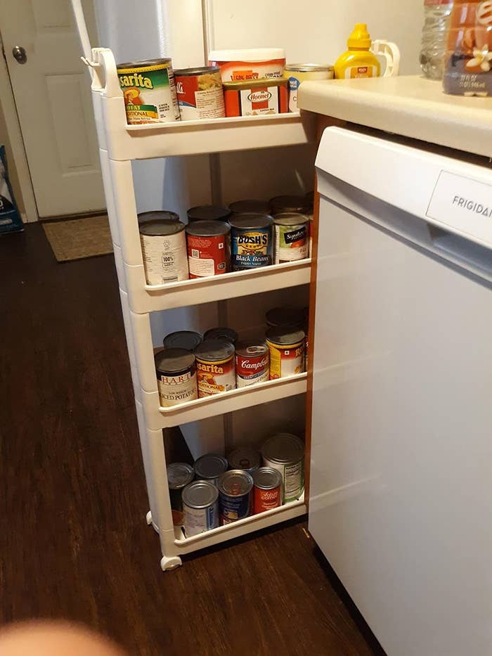 Reviewer image of the rack, which holds cans and other items on shelves that are slightly covered on the edges so that the cans cannot fall off easily