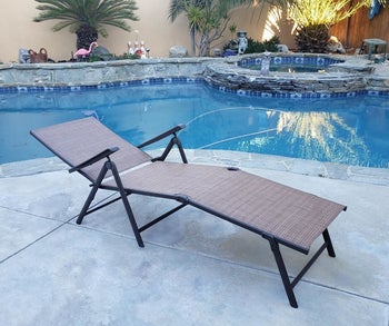 a reviewer photo of the chaise lounge in aa flat reclined position 