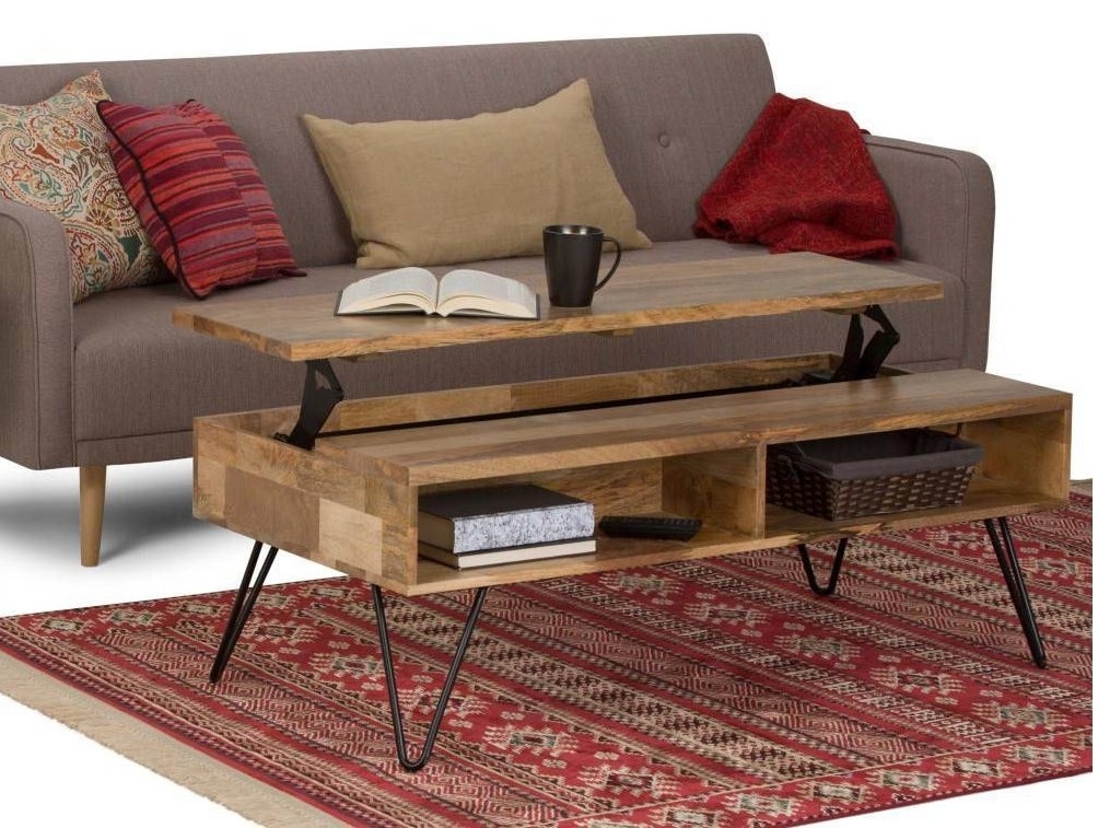 The table with the raised part raised, with a couch and rug
