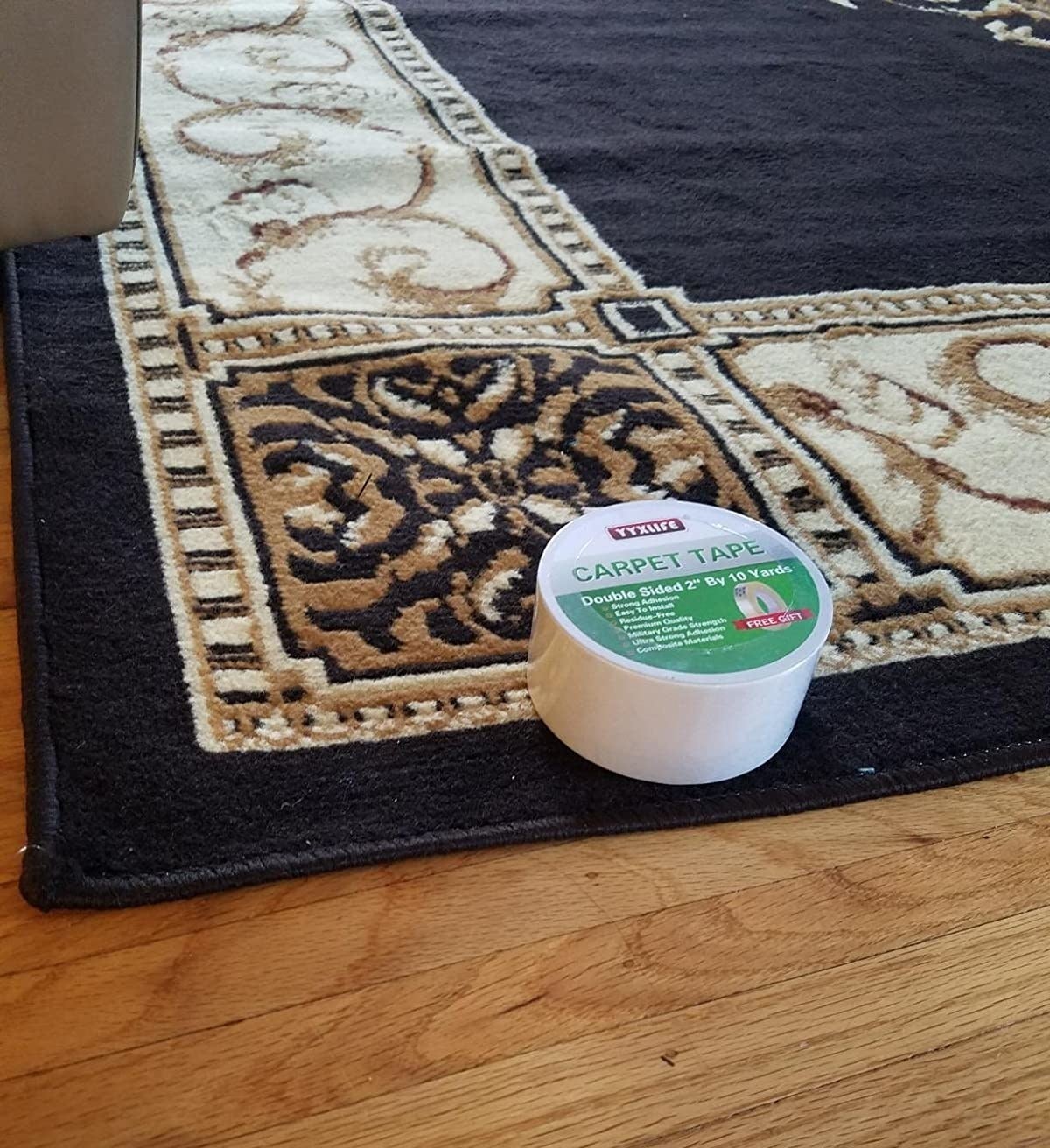 reviewer&#x27;s rug on wood floor with a roll of the tape