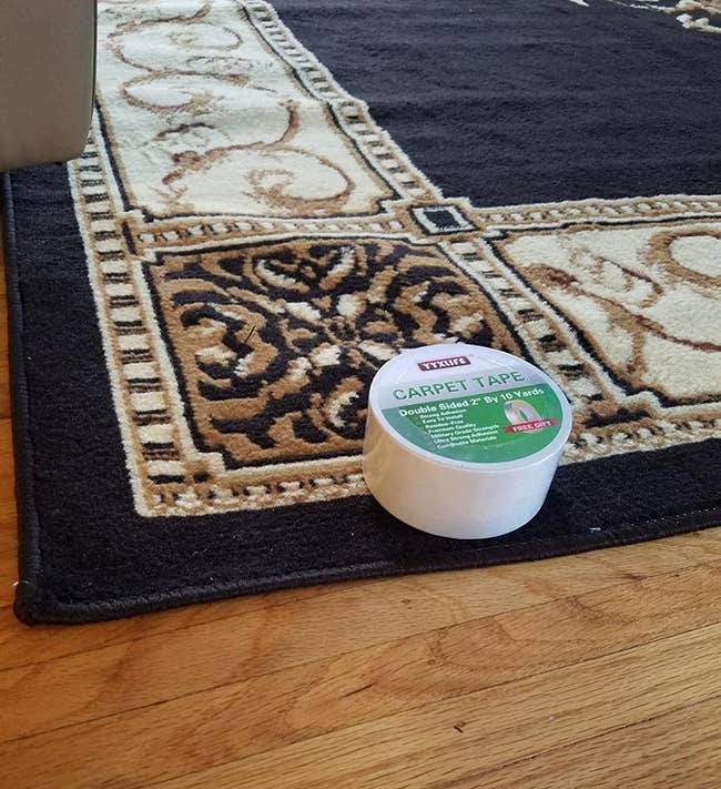 reviewer's rug on wood floor with a roll of the tape