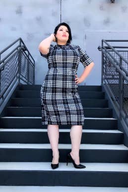 curvy reviewer wearing the boatneck pencil skirt with heels