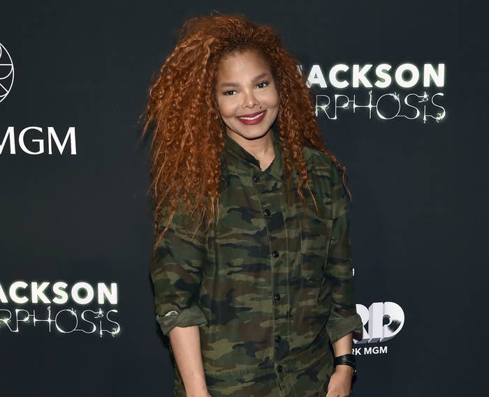 Janet wears a camouflage jumpsuit
