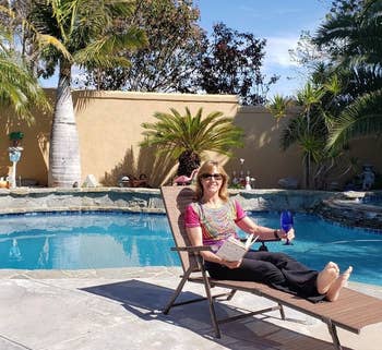 a reviewer photo of someone sitting in one of the reclining chaise lounge chairs 