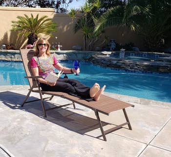 a reviewer sitting in one of the reclining chaise lounge chairs 