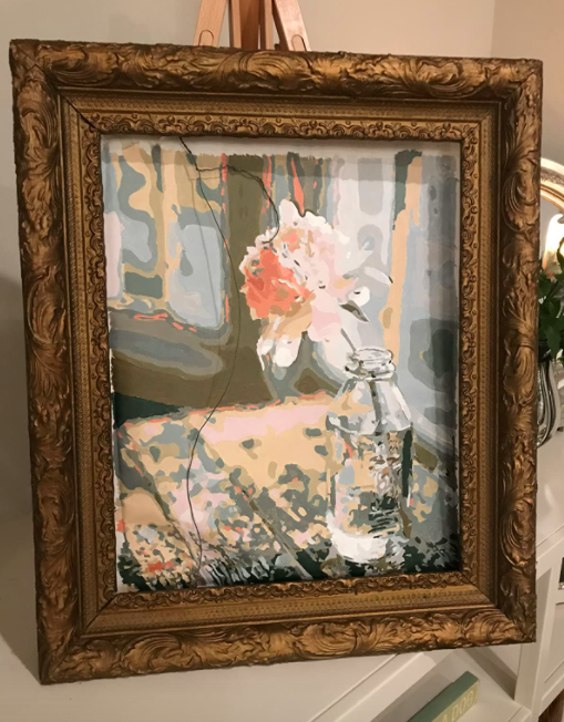 A customer review photo of their framed completed canvas