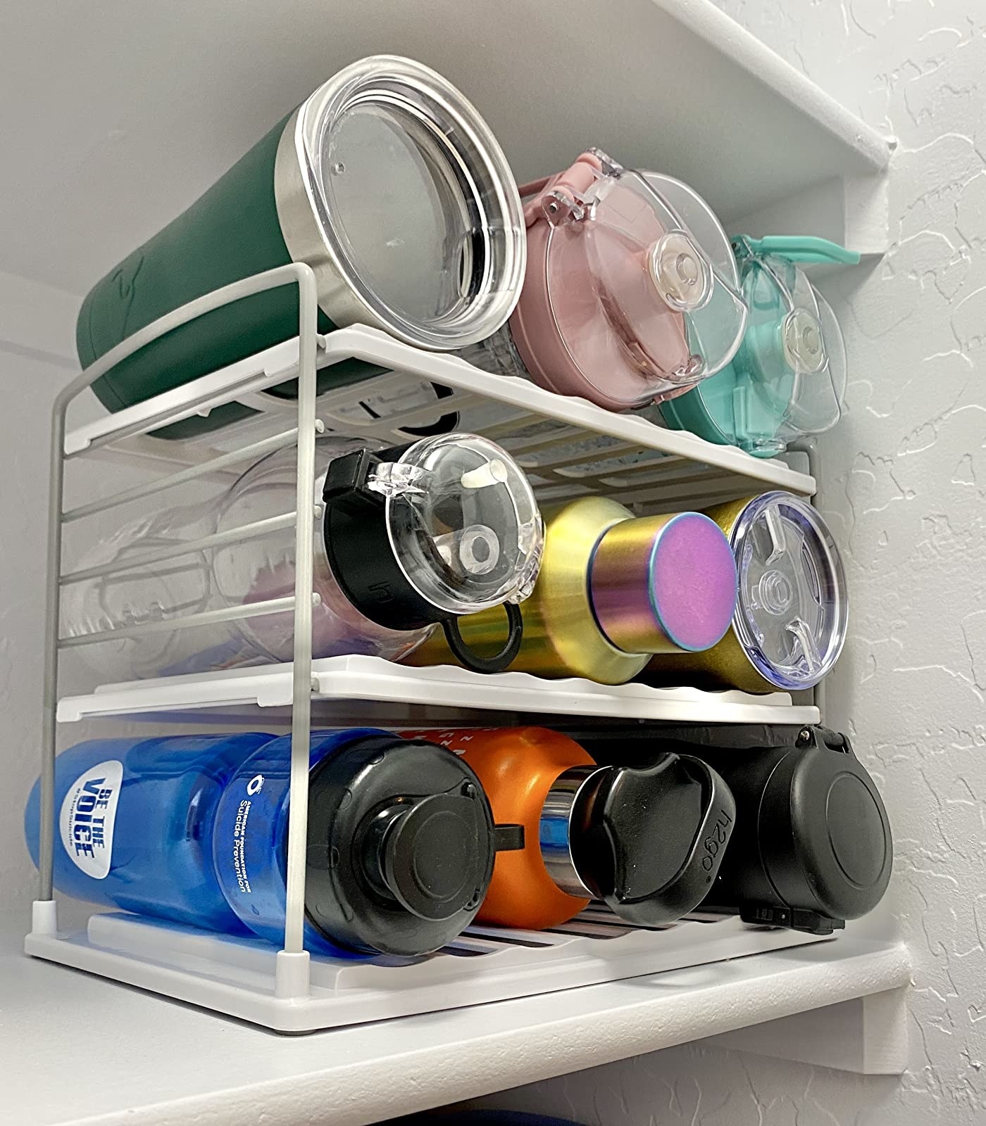 Reviewer photo of the three-level rack, which can hold about nine water bottles, three on each level