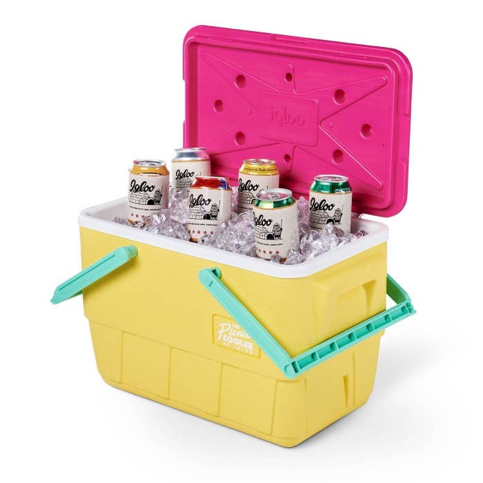 The yellow, green, and pink cooler with beverages and ice in it