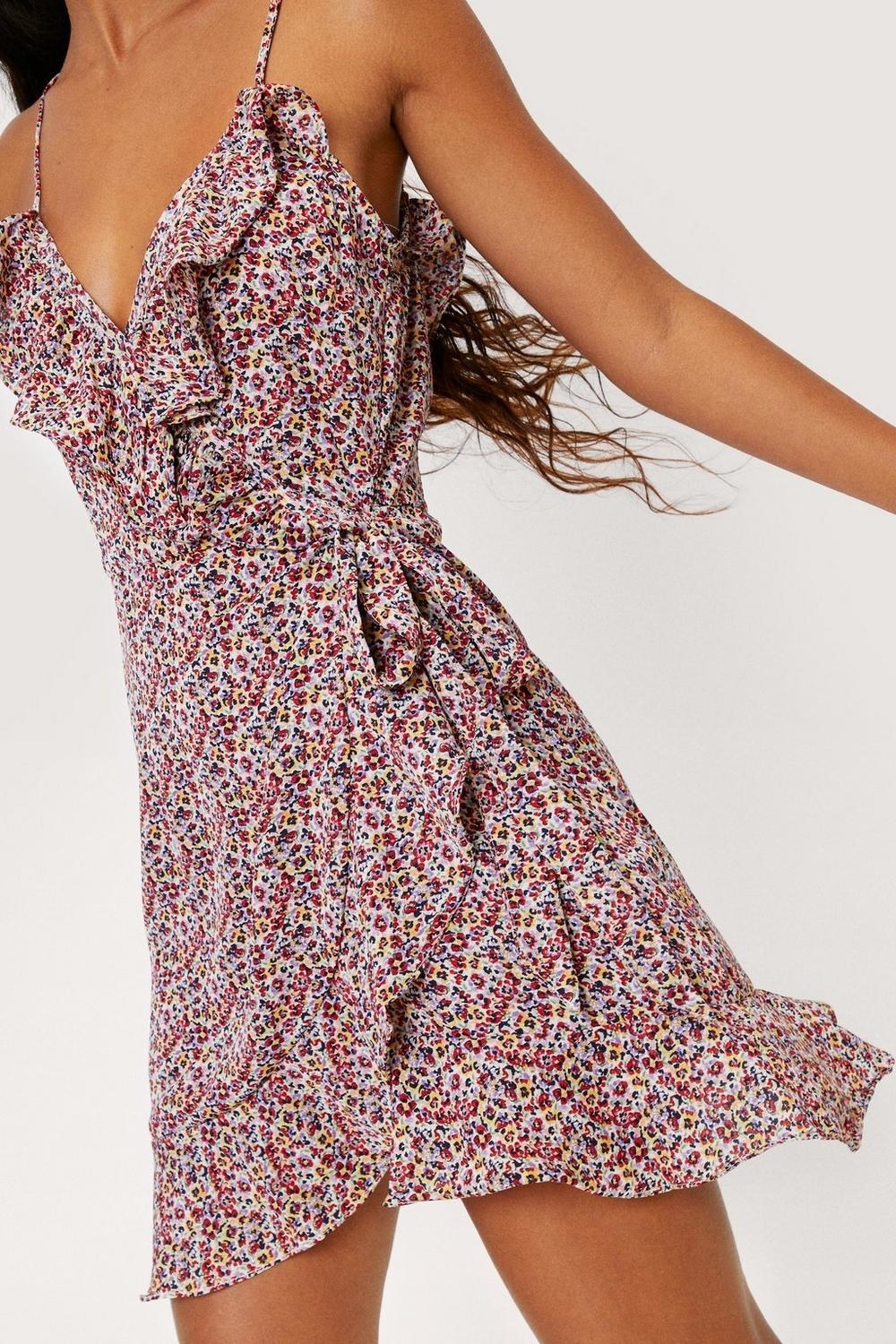 a person wearing the ruffled floral wrap dress